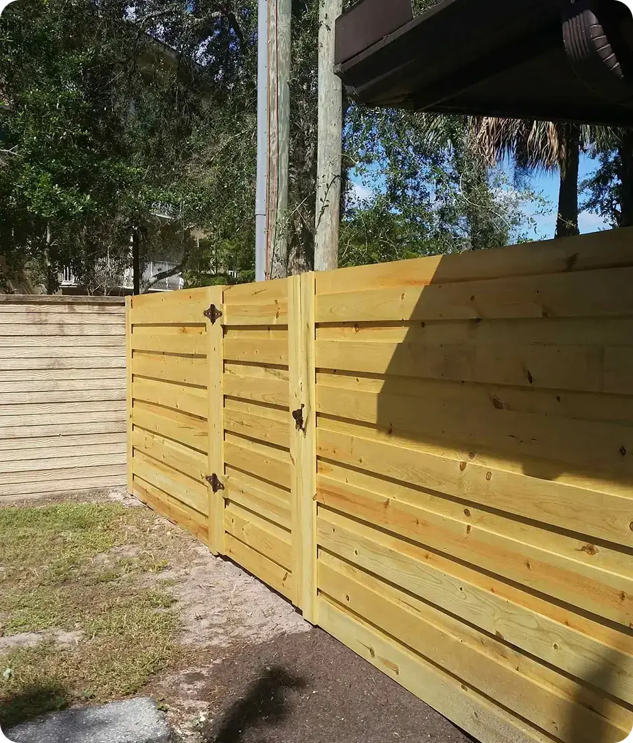 Horizontal wood privacy fence with matching double gate by Premier Fence of SWFL