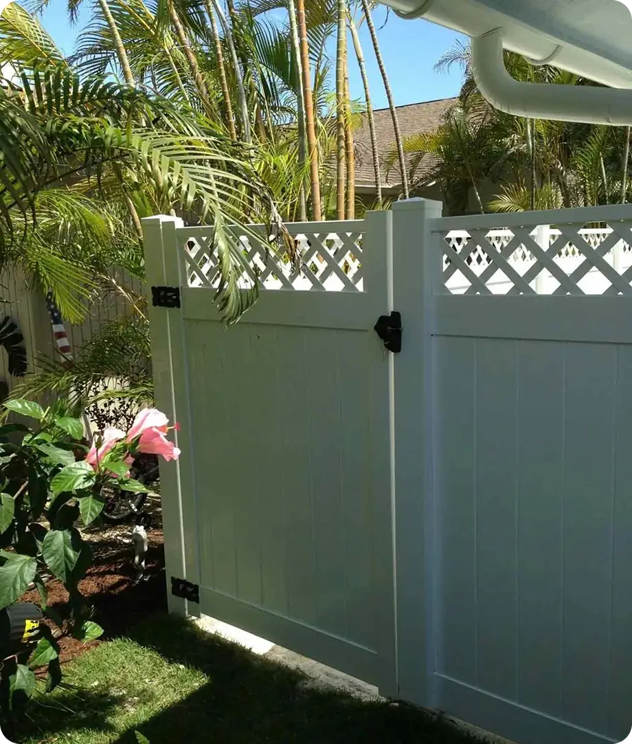 Sage green vinyl privacy fence with lattice top and walk gate by Premier Fence of SWFL