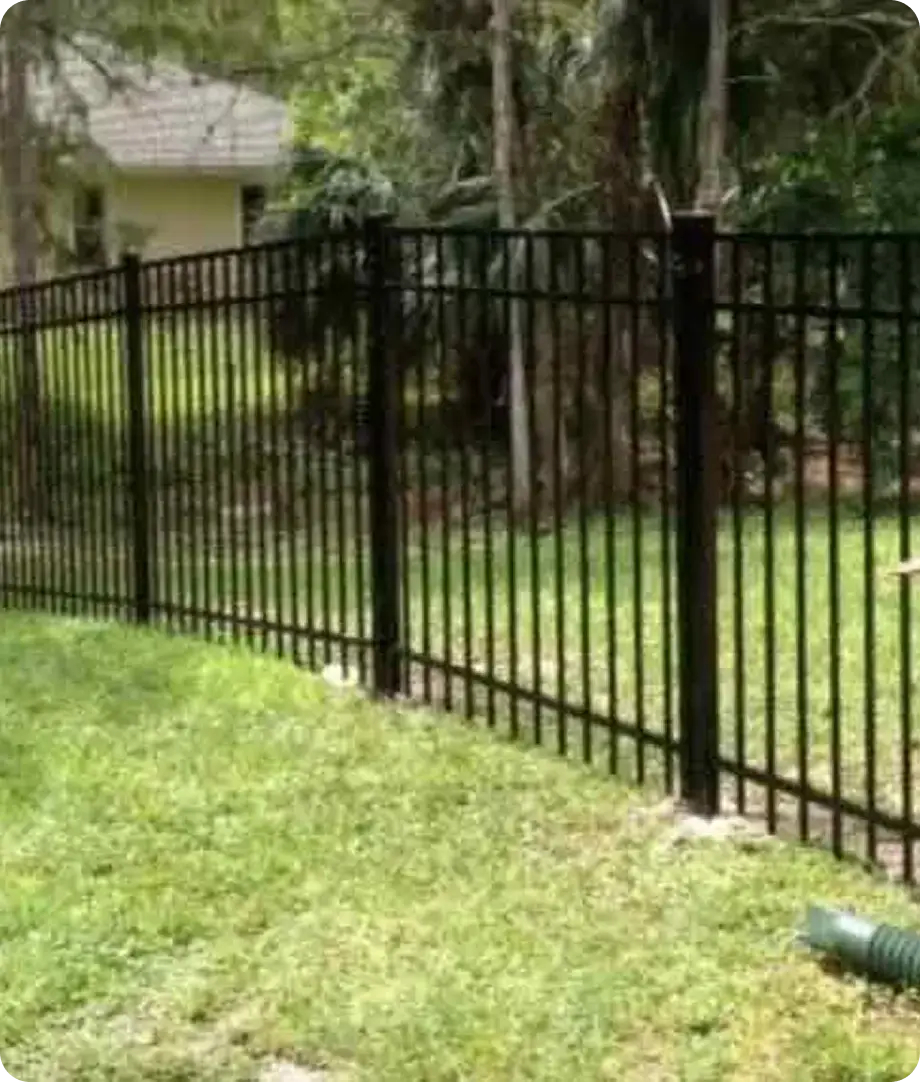 Black aluminum picket fence around a backyard lawn by Premier Fence of SWFL