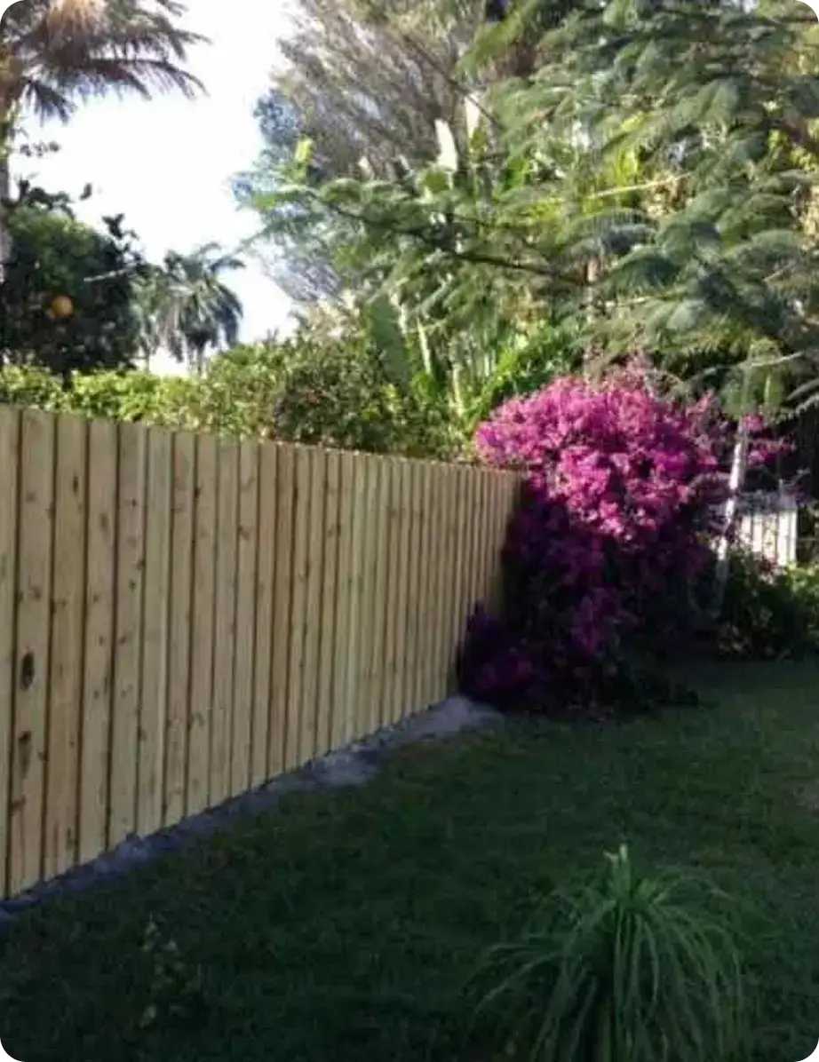 Wood board privacy fence along a landscaped side yard by Premier Fence of SWFL