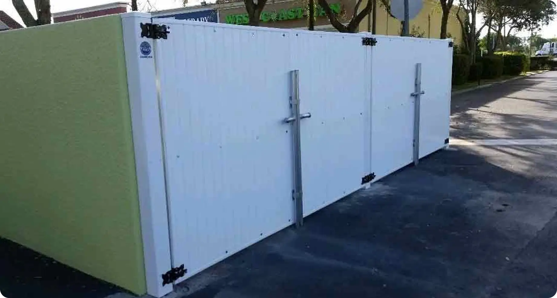 White vinyl privacy enclosure with gate drop rod by Premier Fence of SWFL